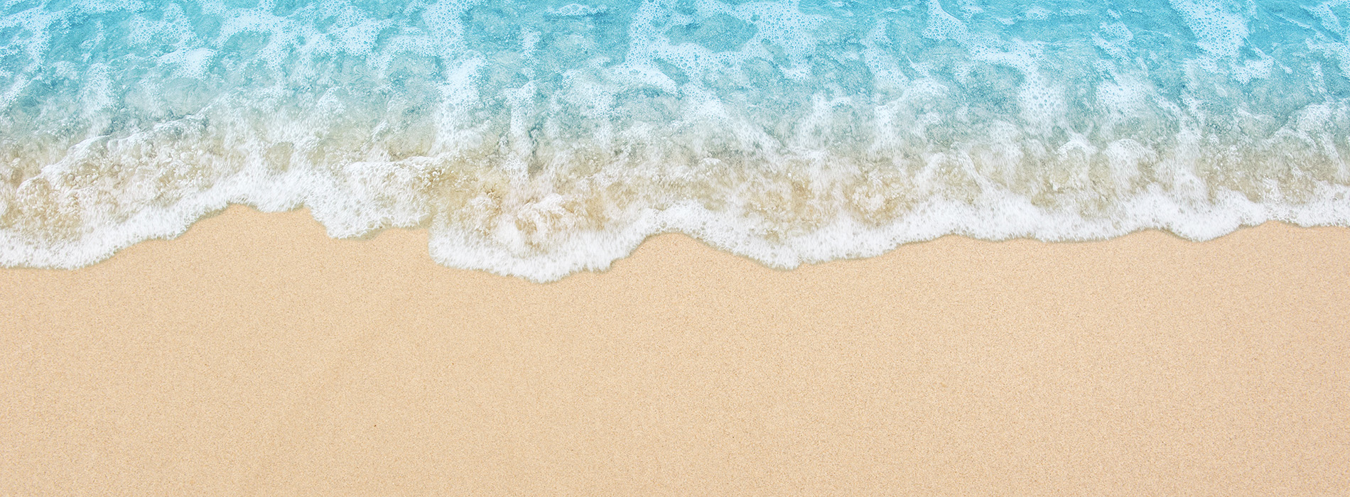 The image displays a sandy beach with crashing waves, viewed from above.